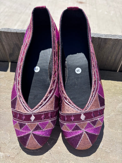Embroidered  ballet pumps with a rubber sole.